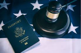 Passport and gavel atop an American flag