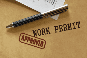 Work permit with a stamp that says "approved"